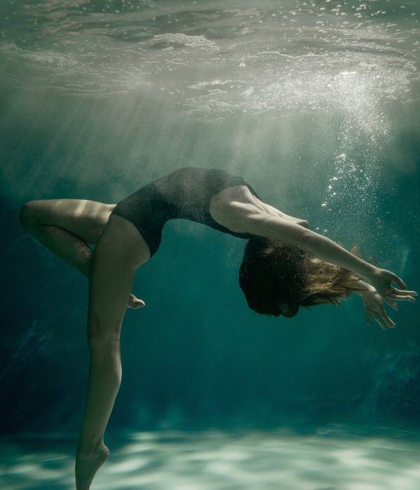 Woman in a dynamic yet graceful pose suggesting fluid motion.